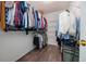 Walk-in closet filled with hanging clothes, shelving and laminate flooring, providing organized storage at 3876 Toccoa Falls Dr, Duluth, GA 30097