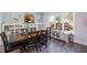 Bright dining room with a dark wood table, matching chairs, stylish lighting, and large windows offering ample light at 3876 Toccoa Falls Dr, Duluth, GA 30097