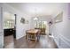 Light-filled dining room featuring hardwood floors, wainscoting, stylish chandelier, and large windows at 3876 Toccoa Falls Dr, Duluth, GA 30097