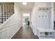 Inviting foyer featuring hardwood flooring, staircase with iron railing, and decorative coat rack with bench seating at 3876 Toccoa Falls Dr, Duluth, GA 30097