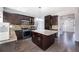 Modern kitchen with dark wood cabinetry, granite countertops, stainless steel appliances, and a center island at 3876 Toccoa Falls Dr, Duluth, GA 30097