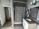 Bathroom with a modern vanity, granite countertop, and a shower with a zebra-patterned curtain at 20 Marietta Nw St # 10E, Atlanta, GA 30303