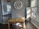Bright dining area featuring a wooden table set, granite countertops, and stylish white cabinetry at 20 Marietta Nw St # 10E, Atlanta, GA 30303