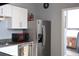 Modern kitchen with stainless steel refrigerator, granite countertops, and white cabinets at 20 Marietta Nw St # 10E, Atlanta, GA 30303