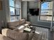 Inviting living room with large windows, city views, comfortable seating, and a decorative rug at 20 Marietta Nw St # 10E, Atlanta, GA 30303