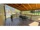 Cozy covered deck features bench seating and space for dining with neighborhood views at 494 Rue Montaigne, Stone Mountain, GA 30083