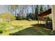 Expansive backyard surrounded by mature trees with covered deck and stair access at 494 Rue Montaigne, Stone Mountain, GA 30083