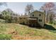 Backyard view of the two-story home with deck and landscaping at 494 Rue Montaigne, Stone Mountain, GA 30083