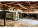 Unfinished basement with exposed beams and ductwork, offering potential for customization at 494 Rue Montaigne, Stone Mountain, GA 30083