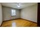 Bedroom with hardwood floors, a ceiling fan, and a window at 494 Rue Montaigne, Stone Mountain, GA 30083