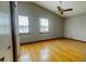 Spacious bedroom features vaulted ceilings, wood floors, and natural light from two windows at 494 Rue Montaigne, Stone Mountain, GA 30083