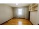 Bedroom with hardwood floors, closet, and a window bringing in natural light at 494 Rue Montaigne, Stone Mountain, GA 30083