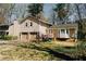 View of the home showcasing the two-car garage and side entry at 494 Rue Montaigne, Stone Mountain, GA 30083