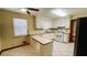 Kitchen featuring white cabinets and countertops, window, and black appliances at 494 Rue Montaigne, Stone Mountain, GA 30083