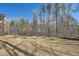 Large backyard with a mix of grass and wooded areas, offering ample space for outdoor activities at 115 Laurelwood Ln, Dallas, GA 30157