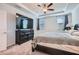 A Primary bedroom featuring a ceiling fan, a large TV, and tray ceiling at 115 Laurelwood Ln, Dallas, GA 30157