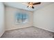 Empty bedroom featuring carpet, natural light from a window and ceiling fan at 115 Laurelwood Ln, Dallas, GA 30157