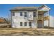Rear exterior view featuring a two-story home, fenced yard, and covered deck perfect for outdoor living at 115 Laurelwood Ln, Dallas, GA 30157