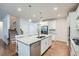 Modern kitchen with stainless steel appliances, white cabinets, a granite island, and hardwood floors at 115 Laurelwood Ln, Dallas, GA 30157