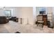 Spacious, carpeted living room featuring a comfortable sectional sofa, desk, and media center at 115 Laurelwood Ln, Dallas, GA 30157