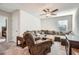 Cozy living room with plush sectional sofa, recliner, ceiling fan, and natural light from window at 115 Laurelwood Ln, Dallas, GA 30157