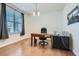 Office space features hardwood floors, a large window, and a sleek desk setup perfect for remote work at 115 Laurelwood Ln, Dallas, GA 30157