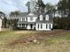 Traditional white home with black shutters, covered porch, and a spacious front yard at 2105 Fair Ridge Ct, Jonesboro, GA 30236