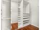 Walk-in closet showcasing custom shelving and wood floors at 2404 Caneridge, Marietta, GA 30064
