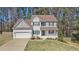 Traditional home with gray and white exterior, large front lawn, and a two-car garage at 2404 Caneridge, Marietta, GA 30064