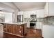 Well-equipped kitchen with stainless steel appliances, island, and mosaic backsplash at 2404 Caneridge, Marietta, GA 30064