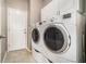 Bright laundry room featuring a modern washer and dryer with white cabinets at 2404 Caneridge, Marietta, GA 30064