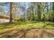 Expansive backyard with mature trees and a lush green lawn, perfect for outdoor activities at 3645 Larkspur Ter, Decatur, GA 30032