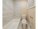 Bright bathroom features a tiled tub and commode with a new toilet seat cover at 3645 Larkspur Ter, Decatur, GA 30032