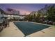 Outdoor pool covered for the winter and surrounded by trees, tables, and chairs for neighborhood residents at 3501 Roswell Ne Rd # 211, Atlanta, GA 30305