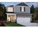 Charming two-story home featuring stone accents, a two-car garage, and a well-manicured lawn at 4825 Marjorie Dr, Cumming, GA 30041