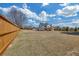 A long wooden fence surrounds the large, grassy backyard of this two-story home with a covered back porch at 195 Hope Hollow Rd, Loganville, GA 30052