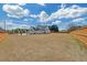 This spacious, grassy backyard is surrounded by a wooden fence, providing privacy for the beautiful home at 195 Hope Hollow Rd, Loganville, GA 30052