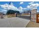 Long driveway with an elegant gated entrance featuring brick columns and a wood fence for privacy at 195 Hope Hollow Rd, Loganville, GA 30052
