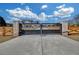 Elegant gated entrance to property featuring brick columns, a metal gate, and a wood fence for privacy at 195 Hope Hollow Rd, Loganville, GA 30052