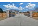 Long driveway with an elegant gated entrance featuring brick columns and a wood fence for added privacy at 195 Hope Hollow Rd, Loganville, GA 30052