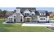 Stunning two-story modern farmhouse with a brick chimney, manicured lawn, and beautiful landscaping at 195 Hope Hollow Rd, Loganville, GA 30052