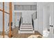 Bright foyer features a staircase with iron railings, beautiful hardwood floors, and a modern design at 195 Hope Hollow Rd, Loganville, GA 30052