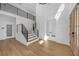 Bright foyer features a staircase with iron railings, beautiful hardwood floors, and a modern design at 195 Hope Hollow Rd, Loganville, GA 30052