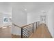 Bright hallway featuring hardwood floors, natural light, and modern railing, creating an inviting transition at 195 Hope Hollow Rd, Loganville, GA 30052