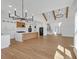 Open concept kitchen with island, stainless appliances, and adjacent staircase at 195 Hope Hollow Rd, Loganville, GA 30052