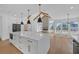 Spacious kitchen with a large island, modern appliances, and an open view into the living area at 195 Hope Hollow Rd, Loganville, GA 30052
