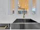 Close-up of a kitchen sink with modern fixtures, complimented by white subway tile and bright natural light at 195 Hope Hollow Rd, Loganville, GA 30052