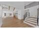 Spacious living room with high ceilings, wood floors, and contemporary staircase at 195 Hope Hollow Rd, Loganville, GA 30052
