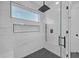 Contemporary shower with modern fixtures, black hardware, and glass doors at 195 Hope Hollow Rd, Loganville, GA 30052