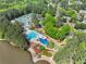 Aerial view features a pool, tennis courts, and lush greenery for a resort-like community experience at 535 Woodbrook Way, Lawrenceville, GA 30043